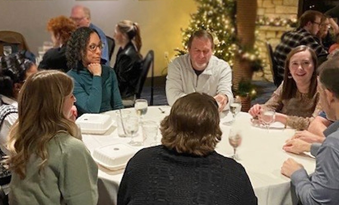 Employees having a fancy dinner together.